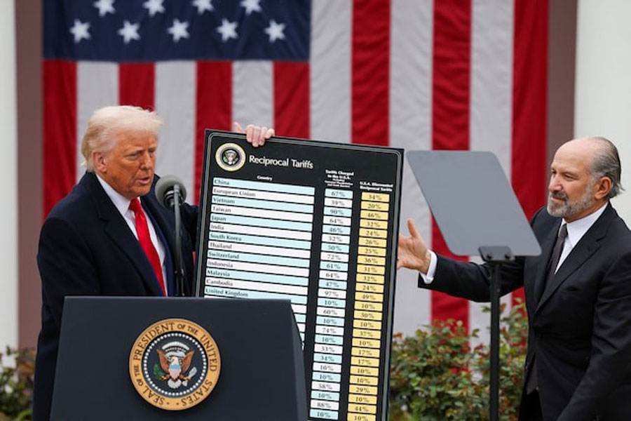 US President Donald Trump holds a chart next to US Secretary of Commerce Howard Lutnick as Trump delivers remarks on tariffs in the Rose Garden at the White House in Washington, DC, US, April 2, 2025.