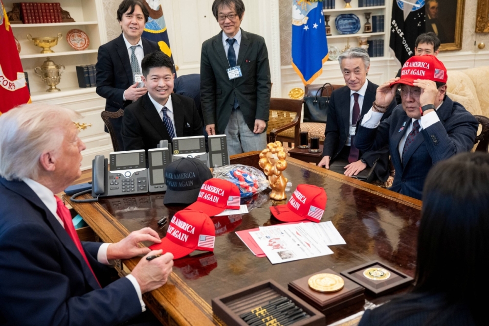 US President Donald Trump meets with Japan's Ryosei Akazawa, who is in charge of trade negotiations with Washington, in the Oval Office of the White House in Washington on April 16. | MOLLY RILEY / VIA REUTERS