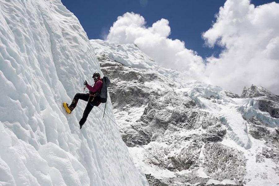 A mountaineer holds on to the rope during an ice climbing session at Everest base camp, Nepal April 15, 2025.