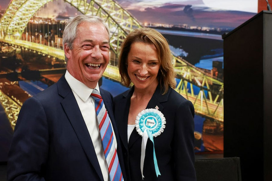 Reform party leader Nigel Farage and candidate Sarah Pochin react as the party wins the Runcorn and Helsby by-election results at Halton Stadium in Widnes, Britain, May 2, 2025.