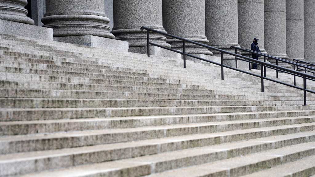 A United States Marshall Service officer waits outside court during the sixth day of the Ghislaine Maxwell trial in the Manhattan borough of New York City, New York, US, December 6, 2021. REUTERS