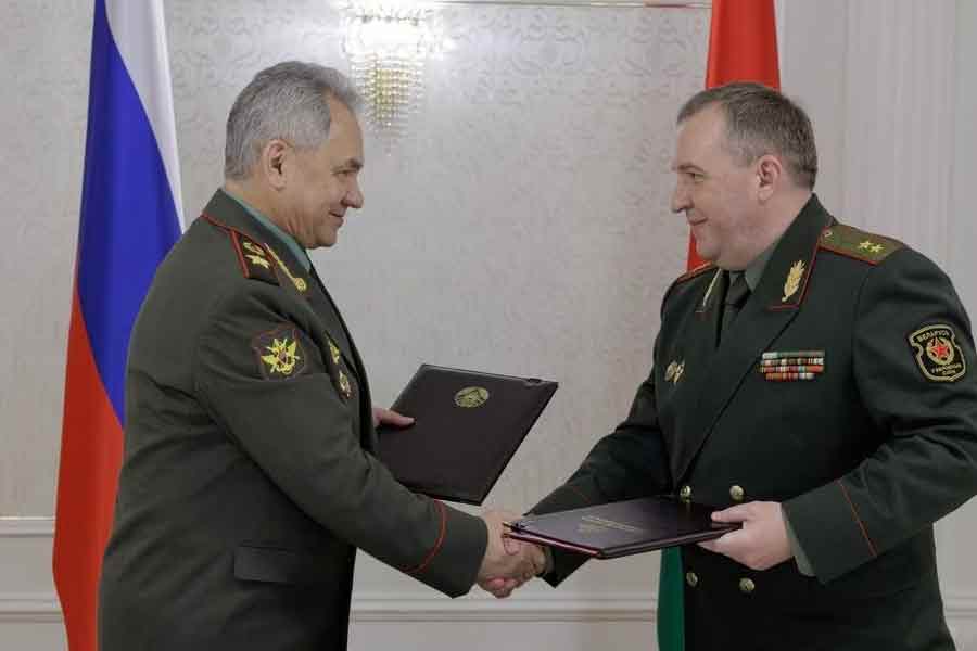 Russian Defence Minister Sergei Shoigu shaking hands with Belarusian Defence Minister Victor Khrenin during a meeting in Belarus on Thursday -Reuters photo