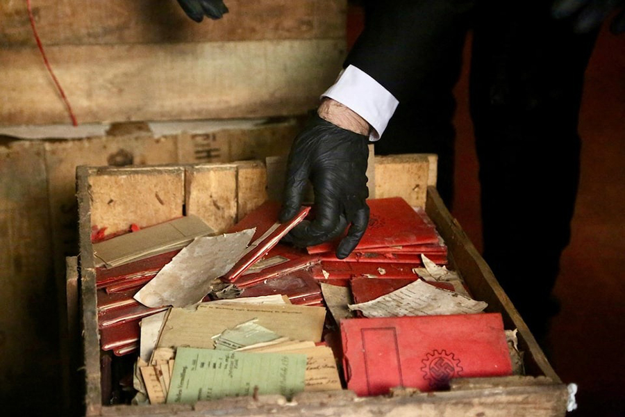 A person holds Nazi-related material that was originally confiscated by local authorities when it was shipped to Argentina in 1941, after several boxes containing the material were recently discovered by chance in the archives of the Supreme Court of Argentina, in Buenos Aires, Argentina in this handout picture released on May 11, 2025 — Corte Suprema de Justicia de la Republica Argentina/Handout via REUTERS photo