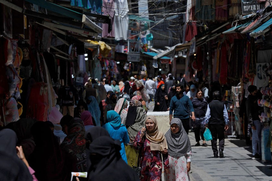 People move in a busy marketplace in Srinagar, Indian Kashmir, May 12, 2025.