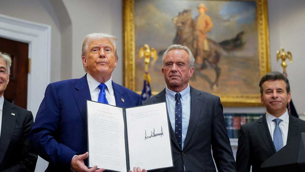 US President Donald Trump holds an executive order on prescription drug pricing next to US Health and Human Services (HHS) Secretary Robert F Kennedy, Jr., during a press conference in the Roosevelt Room at the White House in Washington, DC, US, May 12, 2025. REUTERS/Nathan Howard