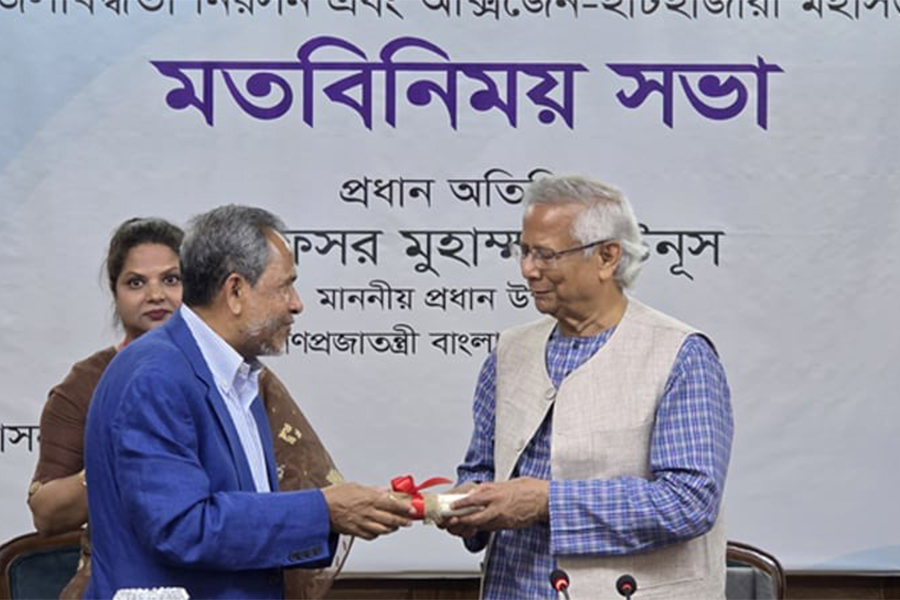 Chief Adviser Professor Muhammad Yunus hands over the land deed of the Chattogram National Heart Foundation to its Chairman, Mohammad Abdus Salam. Photo: CA's Facebook