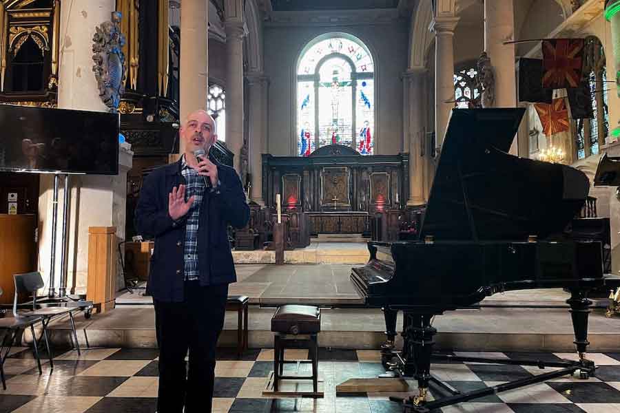 Russian film-maker Roman Liberov addresses the audience at a concert he organised in memory of Pavel Kushnir, a pianist who died in a Russian prison last year, in a church in London, Britain, May 10, 2025.