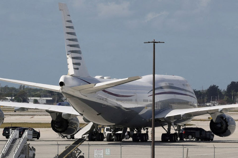 The motorcade of US President Donald Trump is parked next to a 12-year old Qatari-owned Boeing 747-8 that Trump was touring in West Palm Beach, Florida, US, February 15, 2025.