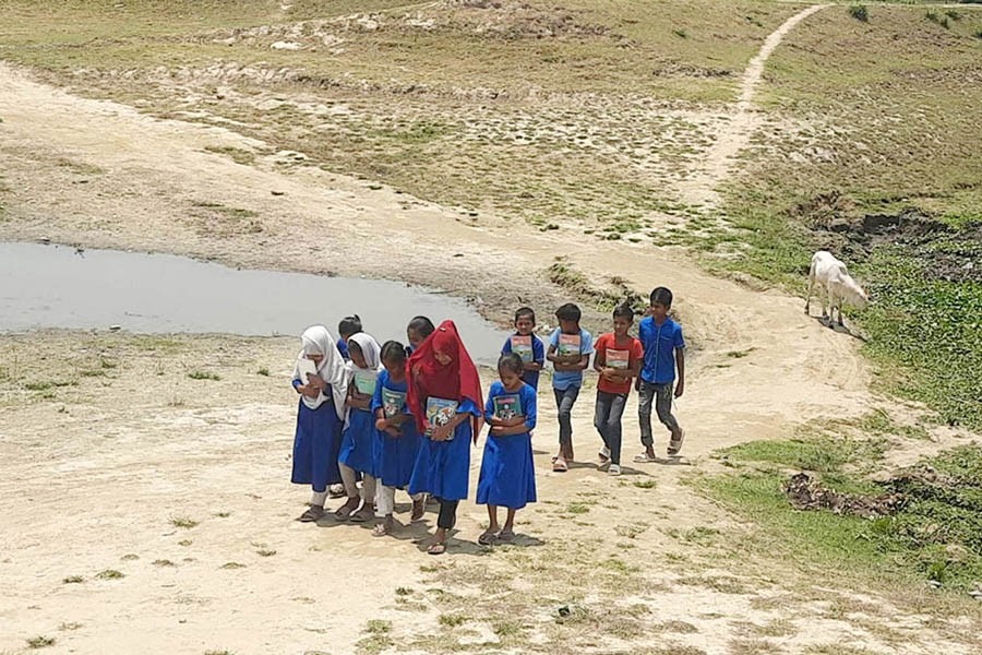 Children travel about three kilometres to attend school daily as there is no school nearby. The photo was taken from Bengauta village in Nasirnagar upazila of Brahmanbaria district on Monday (May 22).