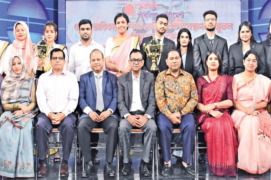 Director General of the Directorate of National Consumers Rights Protection AHM Shafiquzzaman and Debate for Democracy Chairman Hasan Ahmed Chowdhury Kiron, among others, pose with the champion and runner team of the mock parliament session organised by DfD on FDC premises in the city on Saturday