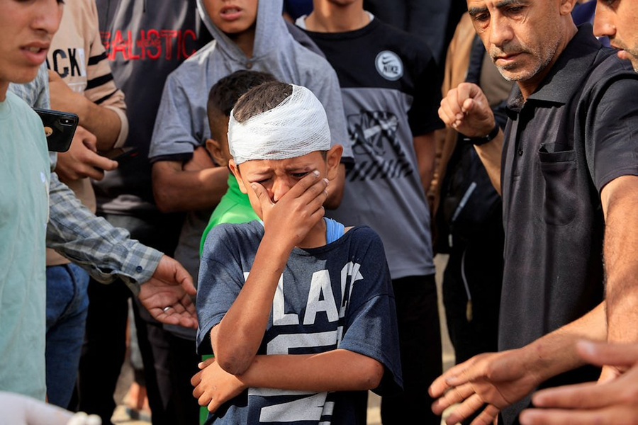 Injured Palestinian child, Yousef Al-Bayouk, weeps over his brothers, Moath and Moataz, who were killed in Israeli strikes, as mourners attend their funeral, at Nasser hospital in Khan Younis, southern Gaza Strip — Reuters photo
