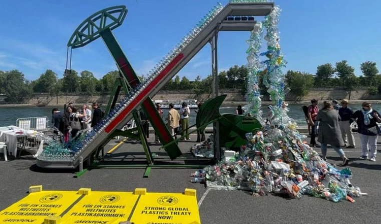 People stand next to artist Benjamin Von Wong's art installation unveiled by the Greenpeace International, ahead of a four-day summit of the United Nations Environment Programme on reducing plastic pollution, in Paris, France May 27, 2023.REUTERS/Yonathan Van der Voort