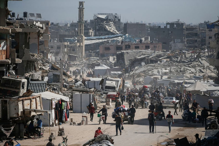 Palestinians make their way with belongings as they fled their homes, after Israeli air strikes, in the northern Gaza Strip May 16, 2025.