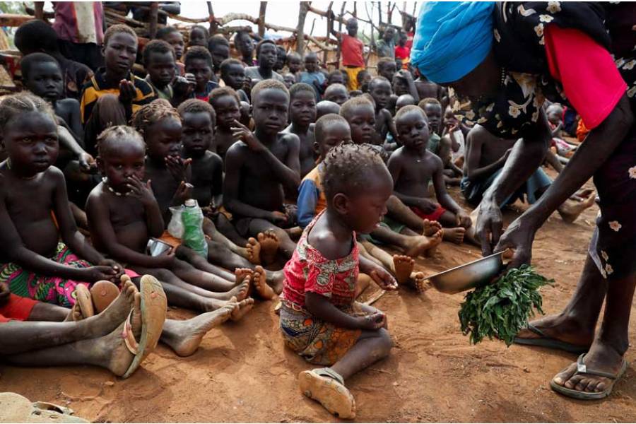 Asha Kano Kavi, an internally displaced woman from Kadugli, serves wild boiled leaves for food to orphaned children at the Bruam IDP Camp within the Sudan’s People Liberation Movement-North (SPLM-N) controlled area in Tobo County in the Nuba Mountains, South Kordofan, Sudan Jun 22, 2024.