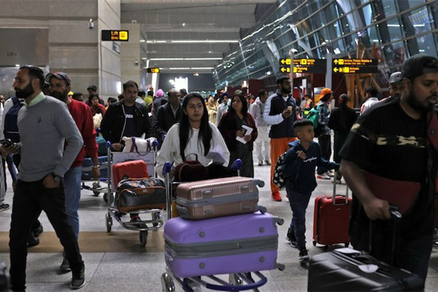 Travellers push carts with their luggage at the departure area of Terminal 3 at Indira Gandhi International Airport in New Delhi, India on December 14, 2022 — Reuters/File