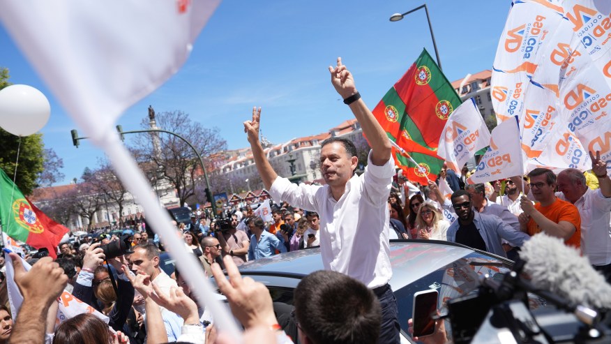 Incumbent Prime Minister and leader of the center-right Social Democratic Party Luis Montenegro gestures to supporters during an election campaign action in downtown Lisbon, Friday, May 16, 2025, ahead of the May 18 general election. (AP Photo/Ana Brigida)