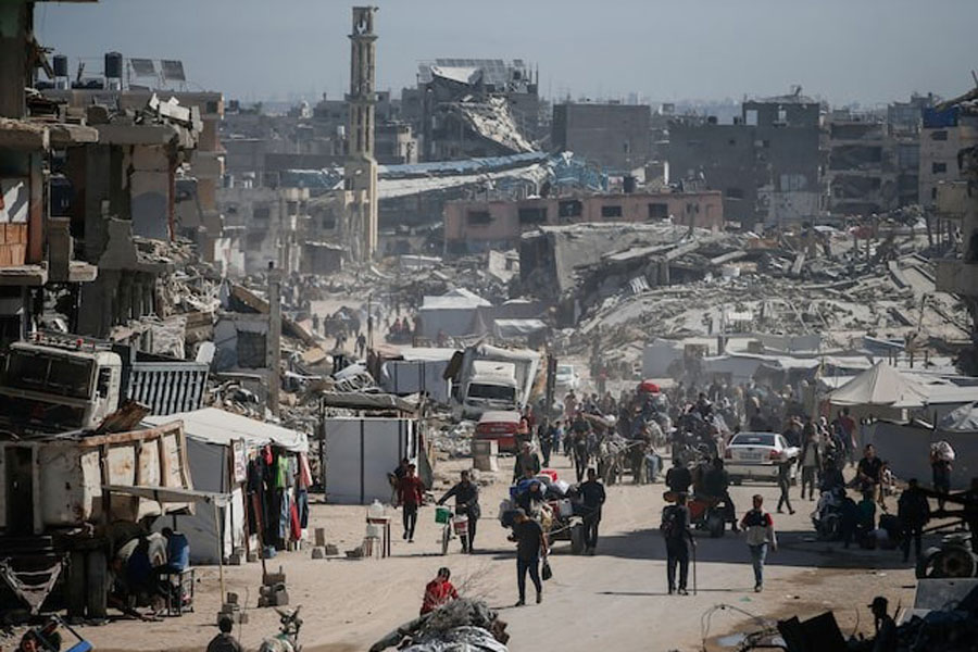 Palestinians make their way with belongings as they fled their homes, after Israeli air strikes, in the northern Gaza Strip May 16, 2025.