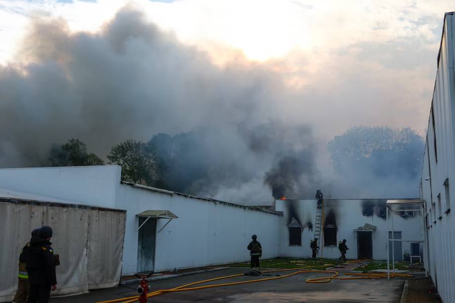 Firefighters work at the site of a private enterprise hit by a Russian drone strike, amid Russia's attack on Ukraine, outside of Kyiv, Ukraine May 18, 2025.