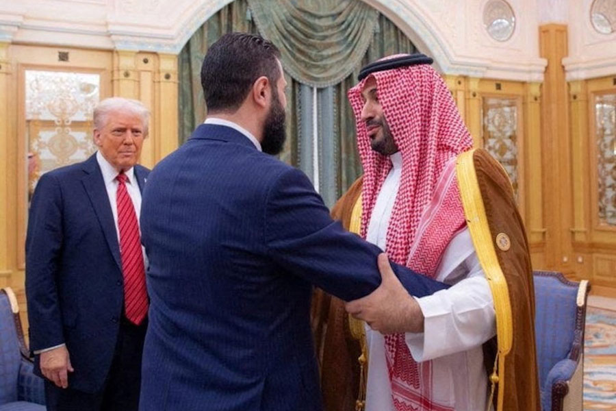 Syrian President Ahmed al-Sharaa meets with US President Donald Trump and Saudi Crown Prince Mohammed Bin Salman in Riyadh, Saudi Arabia, in this handout released on May 14, 2025.