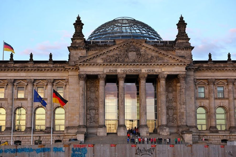 Flags flutter outside the Reichstag building, the seat of the German parliament, the Bundestag, in Berlin, Germany May 6, 2025.