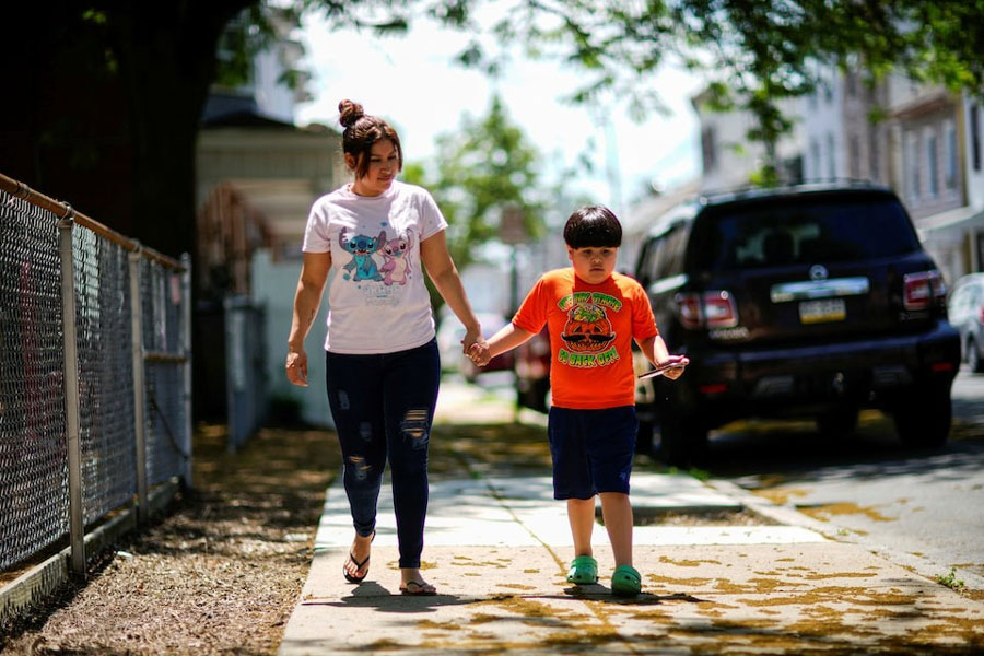 Wendy Elizabeth Ortiz Hernandez walks with her son Axel on a street in Lebanon, Pennsylvania, US, May 17, 2025.