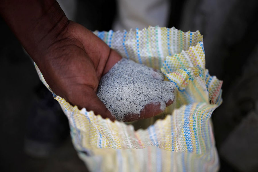 A man displays a coltan ore at the SMB mine near the town of Rubaya in the Eastern Democratic Republic of Congo, August 13, 2019.
