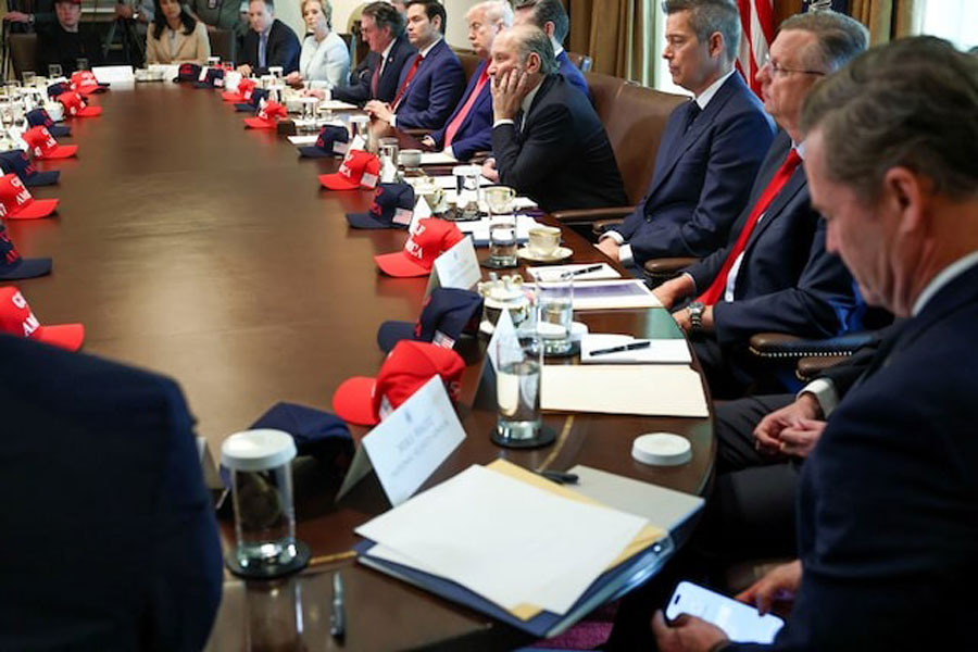 US National Security Advisor Mike Waltz checks his mobile phone while attending a cabinet meeting held by US President Donald Trump at the White House in Washington, DC, US, April 30, 2025.