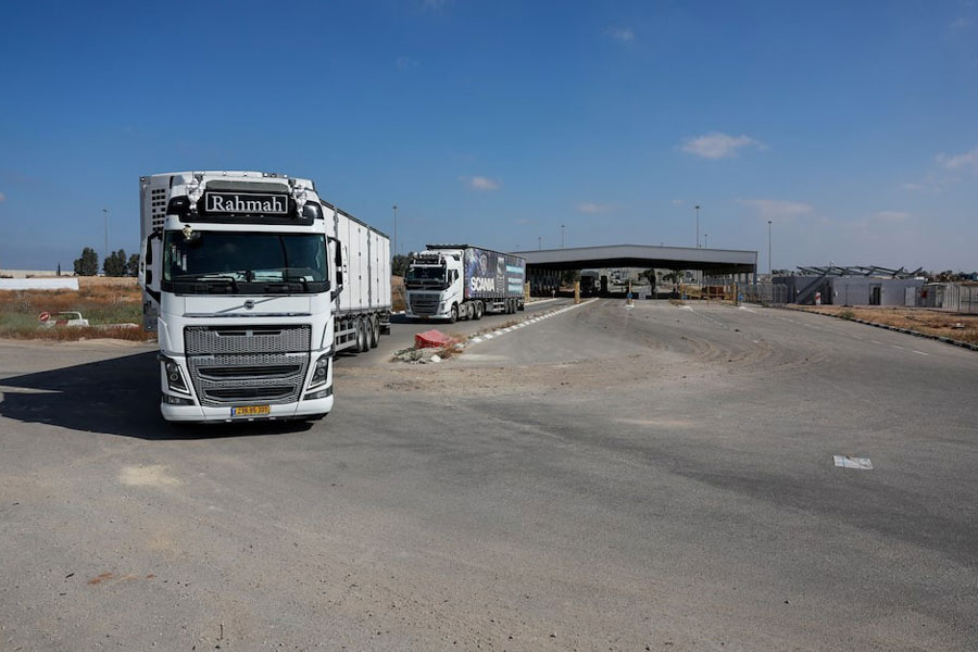 Trucks carrying aid drive at the Kerem Shalom crossing between Israel and Gaza, before going into Gaza, on the Israeli side of the Israel-Gaza border, May 22, 2025.