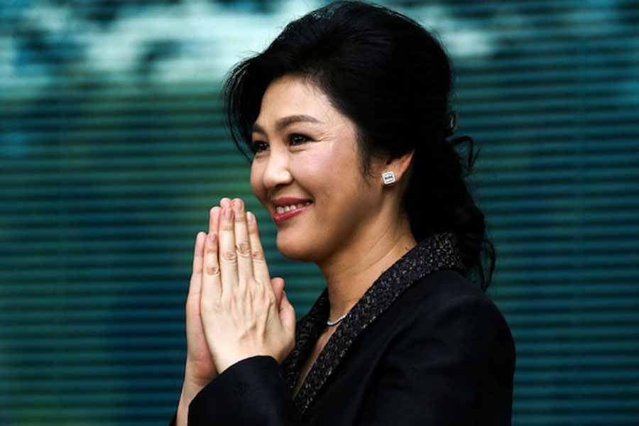 Ousted former Thai prime minister Yingluck Shinawatra greets supporters as she arrives at the Supreme Court in Bangkok, Thailand, August 1, 2017.