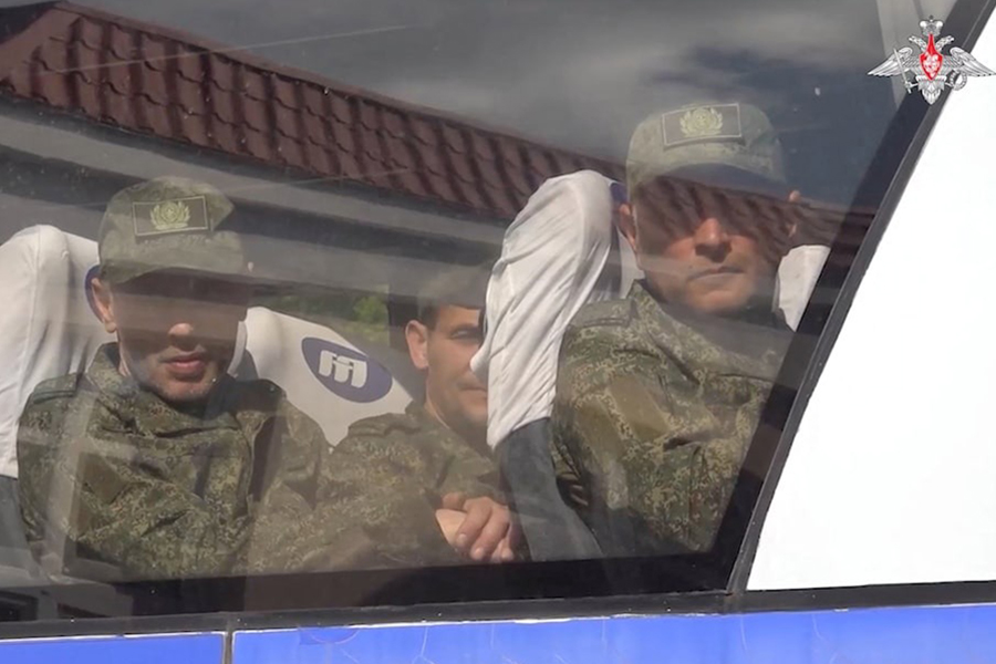 A still image from a video released by the Russian Defence Ministry shows what it said to be Russian service personnel captured by Ukrainian forces and released during the latest exchange of prisoners of war in the course of Russia-Ukraine conflict, as they sit in a bus at an unknown location in Belarus, in this image taken from handout footage released May 23, 2025 — Russian Defence Ministry/Handout via REUTERS