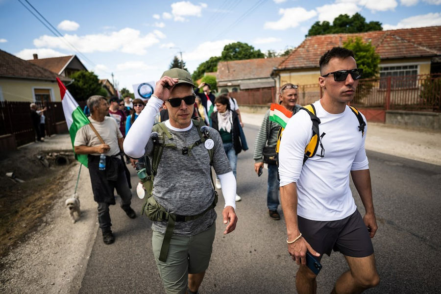 Hungarian opposition leader Peter Magyar walks with his supporters toward Oradea to gain the support of ethnic Hungarians in Romania, in Tapioszentmarton, Hungary, May 16, 2025.