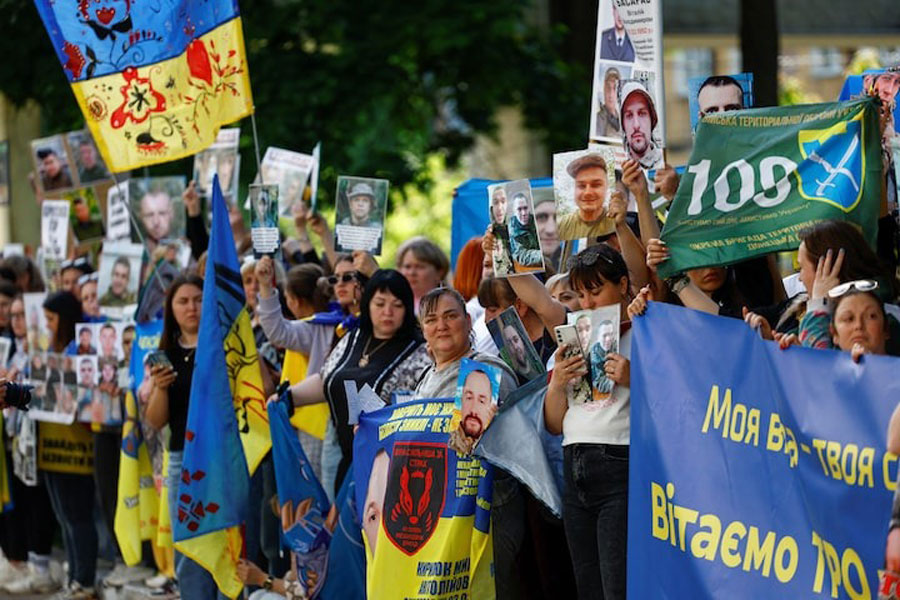 Relatives of Ukrainian prisoners of war (POWs) wait for their arrival after a swap, amid Russia's attack on Ukraine, in an undisclosed location in Ukraine, May 23, 2025.