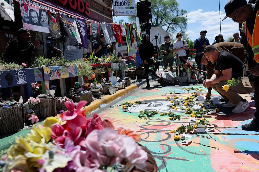 Jazz Hampton lays a rose as he and other community, family and friends pay their respects at the memorial site where George Floyd was murdered by former police officer Derek Chauvin ahead of the fifth anniversary of Floyd’s death in Minneapolis, Minnesota, US, May 23, 2025.
