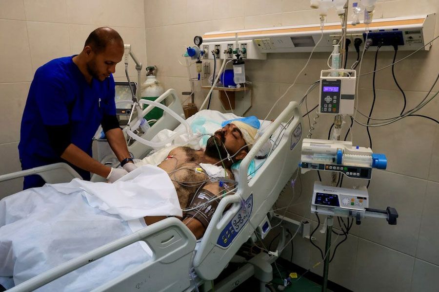 Hamdi Al-Najjar, a wounded Palestinian father and doctor who, according to medics, lost nine of his children in an Israeli strike on Friday, lies in a hospital bed in the Intensive Care Unit at Nasser Hospital after being injured in the same strike, in Khan Younis, in the southern Gaza Strip, May 25, 2025.