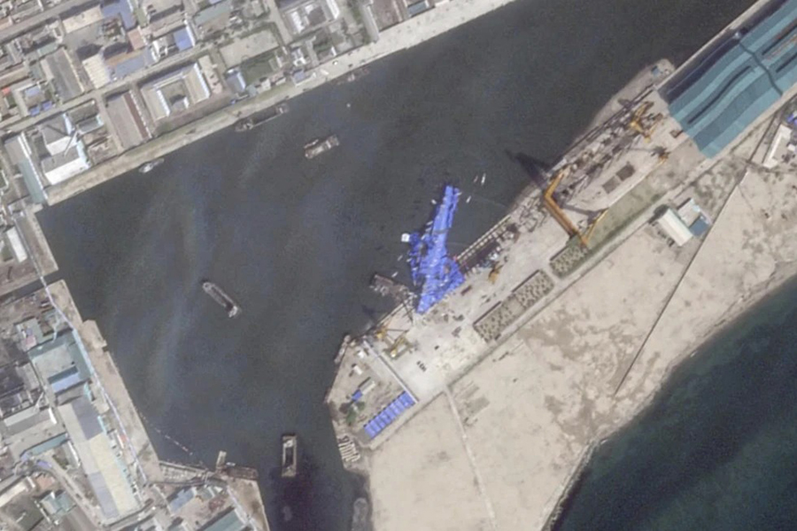 This satellite image from Planet Labs PBC shows a blue tarp covering a North Korean destroyer after it suffered a failed launch while it was being put to sea in Chongjin, North Korea, Friday on May 23, 2025 — Planet Labs PBC via AP