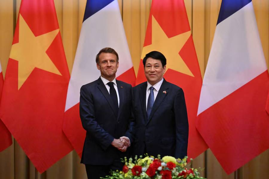 France's President Emmanuel Macron and Vietnam's President Luong Cuong shake hands during a meeting at the Presidential Palace in Hanoi on May 26, 2025.
