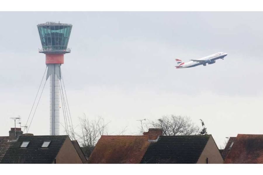 A British Airways passenger plane takes off behind houses at Longford near Heathrow Airport, west London, Britain, Jan 28, 2025.