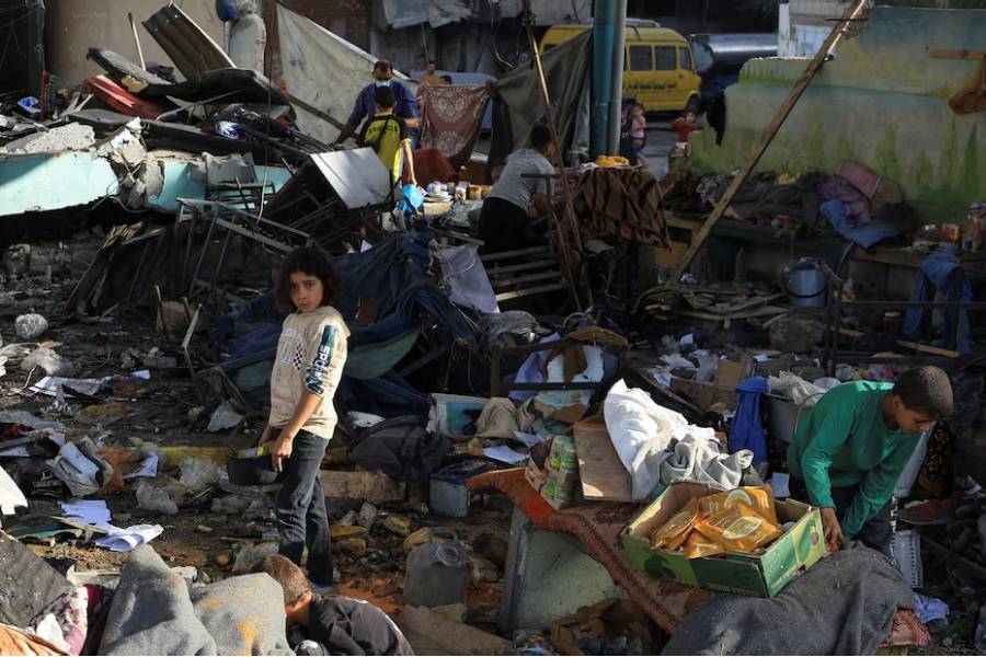 Palestinians inspect the damage at a school sheltering displaced people, following an Israeli strike, in Gaza City, May 26, 2025.