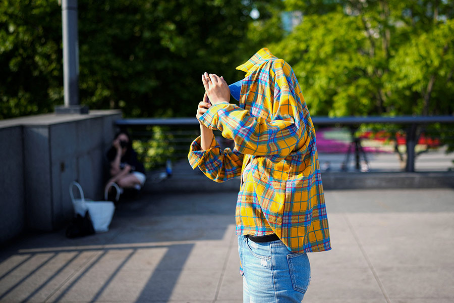 A person using clothing to protect him from the sun, as they walk on the Bund on a hot day, in Shanghai of China on May 15 this year –Reuters file photo