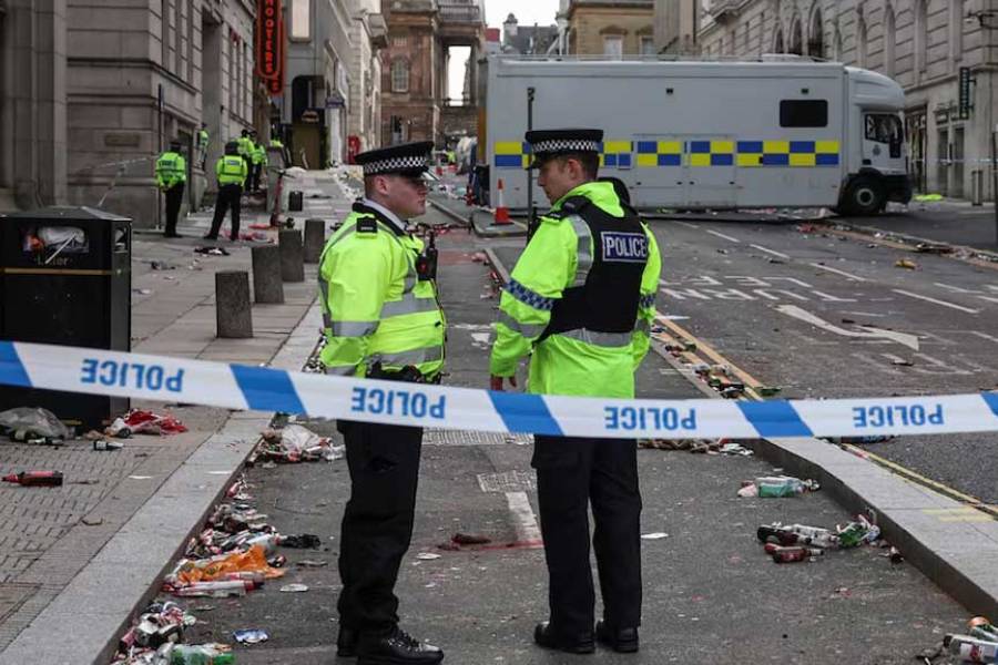 Police officers work at the scene after an incident where a car plowed into a crowd of Liverpool fans during a parade celebrating their side's Premier League soccer title, in central Liverpool, Britain, May 27, 2025.
