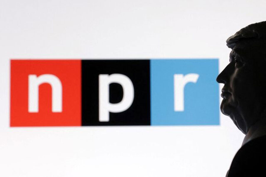 A 3D-printed miniature model of US President Donald Trump with the National Public Radio (NPR) logo in the background is seen in this illustration taken April 23, 2025.