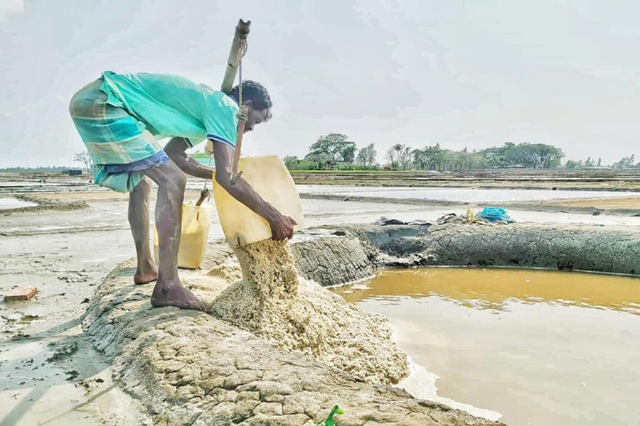 A farmers working in a salt field in Kalamarchhara union under Moheshkhali upazila of Cox's Bazar district