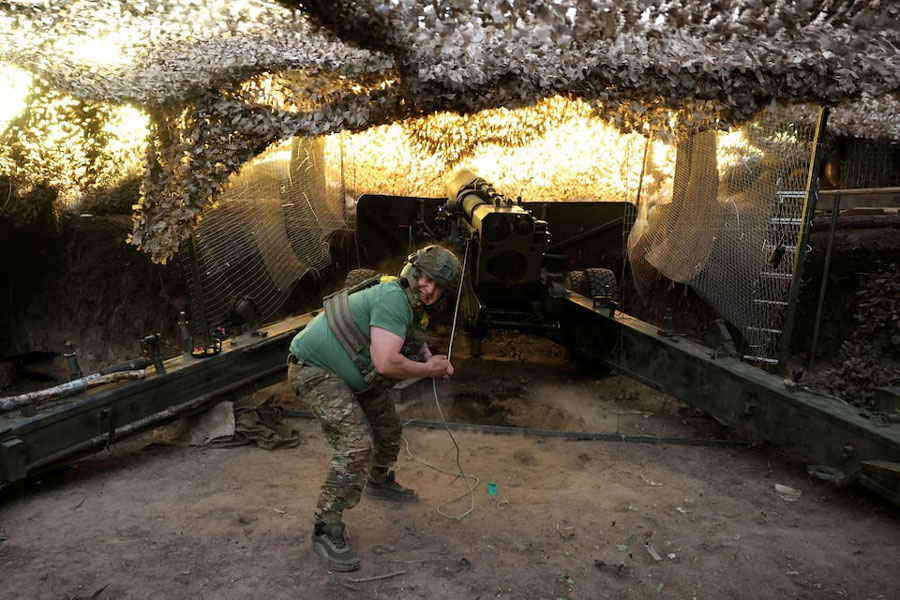 A Ukrainian serviceman fires a howitzer in Kharkiv region, Ukraine, May 27, 2025.