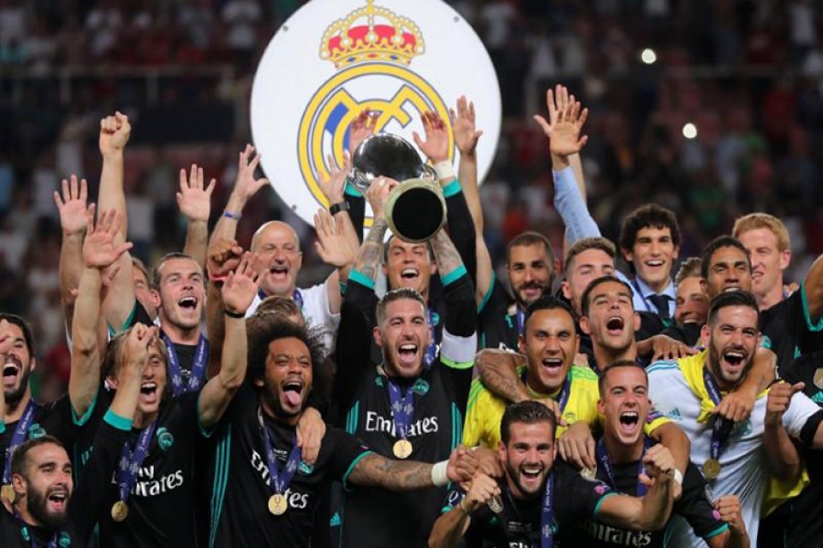 Real Madrid’s Sergio Ramos lifts the trophy as they celebrate winning the super cup final on Tuesday. - Reuters