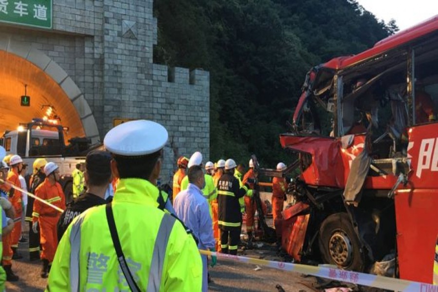 Rescue services worked through the night at the site of an accident after a coach hit the wall of a tunnel in Shaanxi province. - Reuters photo