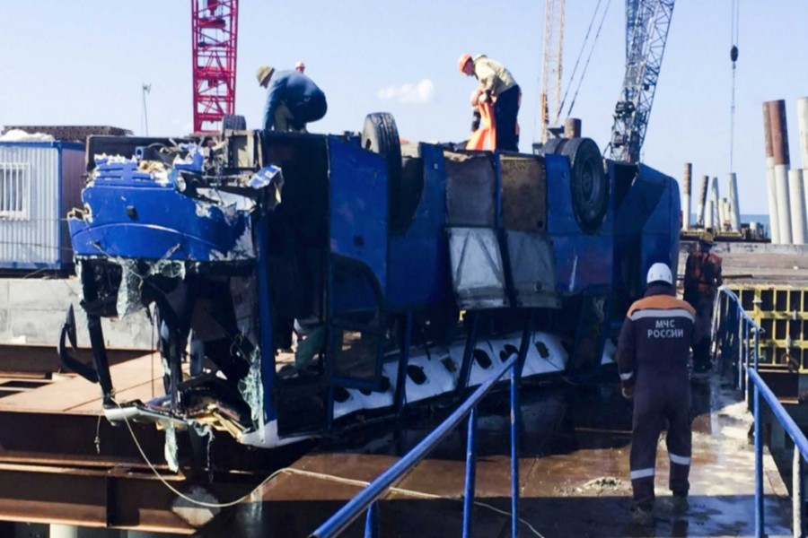 The bus is pulled out of the water at a pier in Volna village, Krasnodar. - Russian Ministry for Emergency Situations/AP photo