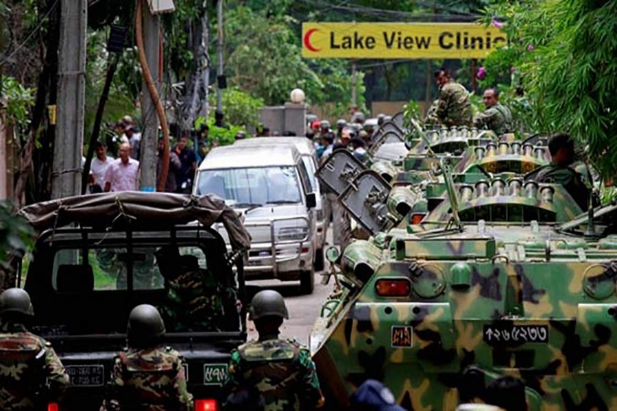 Army vehicles, before a rescue operation, stand guard outside the Holey Artisan Bakery in Dhaka's Gulshan area on July 2, 2016. - AP photo