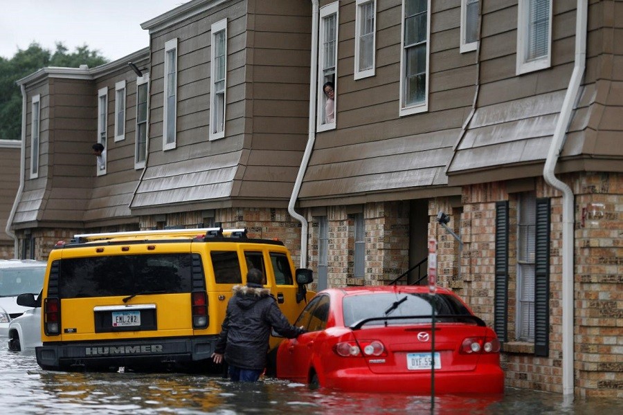Residents talk as flood waters from Tropical Storm Harvey rise in Orange, Texas, US, August 30, 2017. Reuters