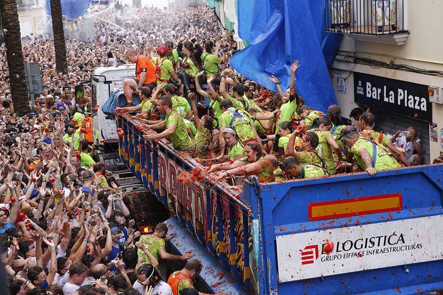 Crowds of people throw tomatoes at each other, during the annual Tomatina tomato fight fiesta in the village of Bunol, 50 kilometres outside Valencia, Spain on Wednesday. - AP photo