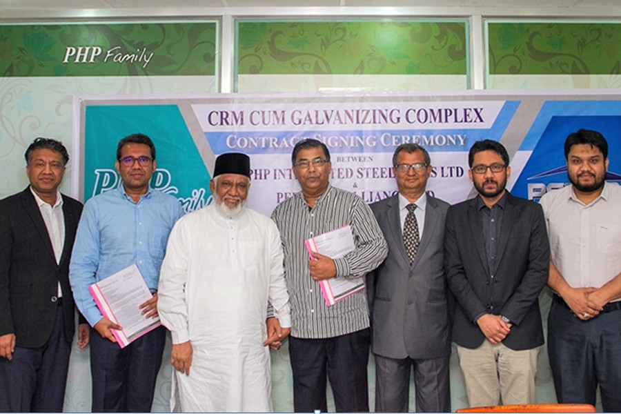 PEBSAL Managing Director Mohammed Iqbal Hossain and PEB Steel Alliance Chairman Engr Newaz Khan exchange documents after signing an agreement in the capital recently.